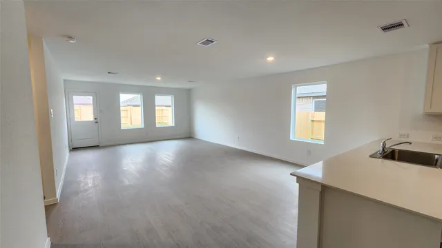 a view of a kitchen and window in a room