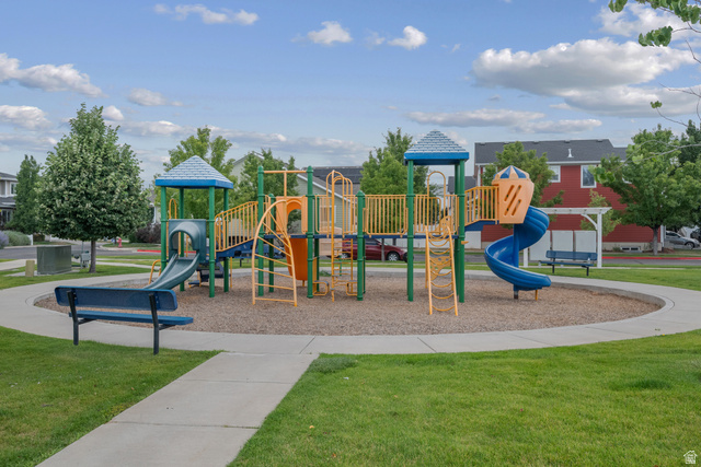 955 Delorean Lane Midvale, UT 84047 - Photo 47 of 47 Community playground featuring a multi-level play structure with slides and ladders, surrounded by a paved walking path
