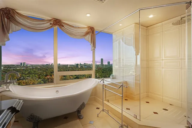 a bathroom with a bathtub and a shower