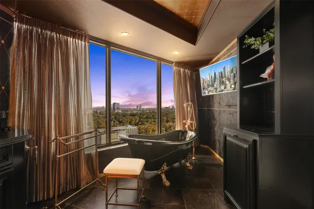 a room with furniture a window and a flat screen tv