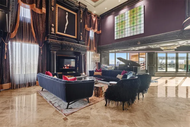 a living room with fireplace furniture and a large window