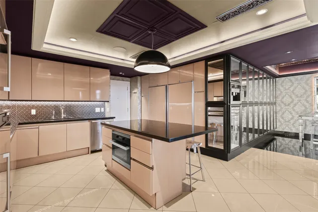 a kitchen with stainless steel appliances kitchen island granite countertop a sink and cabinets