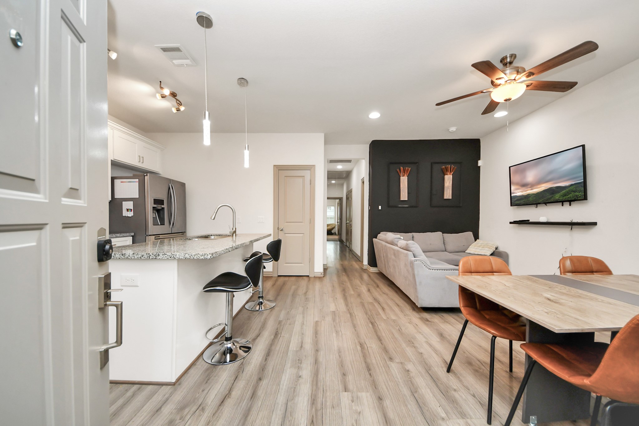 5334 Pershing Street Houston, TX 77033 - Photo 42 of 43 a living room with kitchen island furniture and a flat screen tv