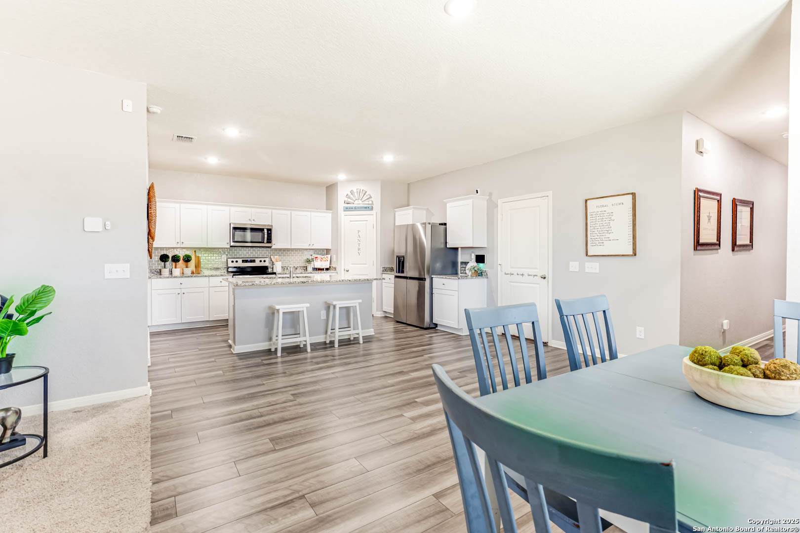 14383 Palm Ridge San Antonio, TX 78253 - Photo 15 of 44 a kitchen with stainless steel appliances kitchen island granite countertop a table chairs and a view of living room
