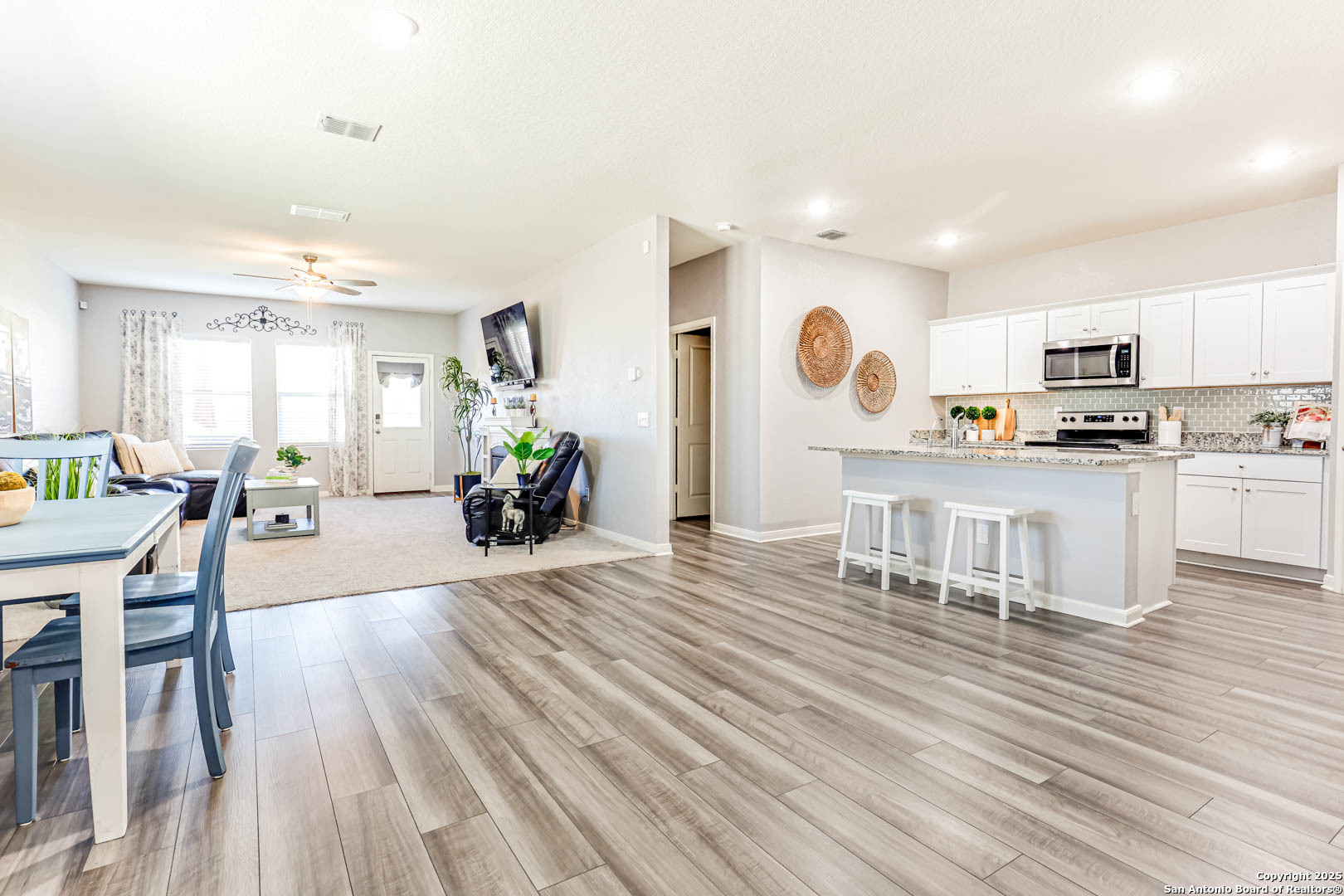 14383 Palm Ridge San Antonio, TX 78253 - Photo 18 of 44 a living room with stainless steel appliances furniture wooden floor and a kitchen view