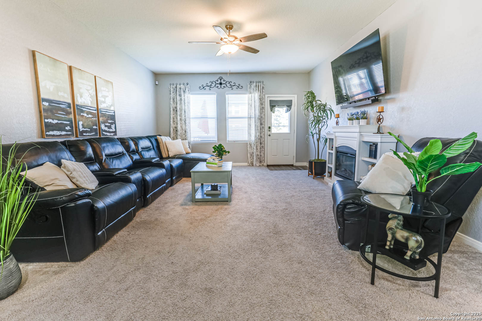 14383 Palm Ridge San Antonio, TX 78253 - Photo 18 of 45 a living room with furniture a fireplace and a flat screen tv