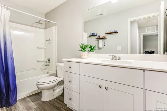 a bathroom with a sink toilet a mirror and shower