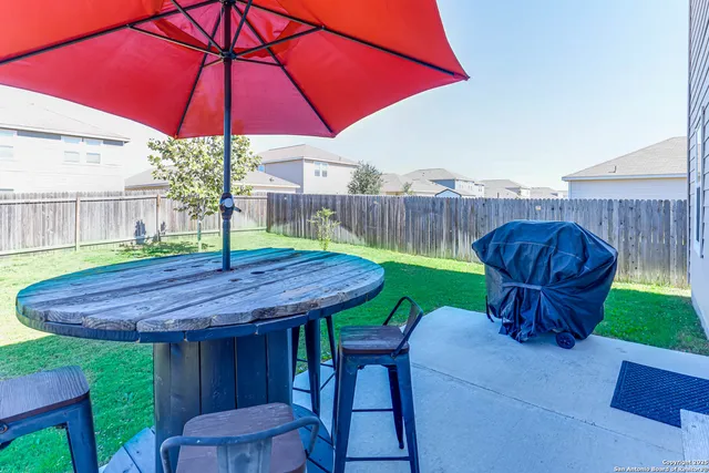 a view of yard with furniture and backyard