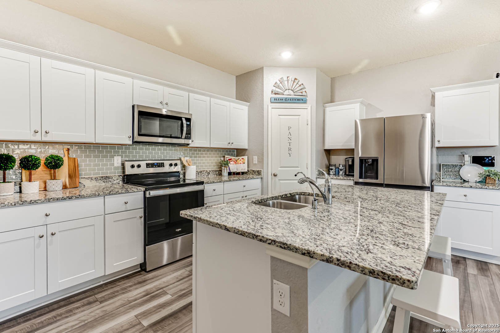 14383 Palm Ridge San Antonio, TX 78253 - Photo 3 of 44 a kitchen with stainless steel appliances granite countertop a sink stove microwave and refrigerator