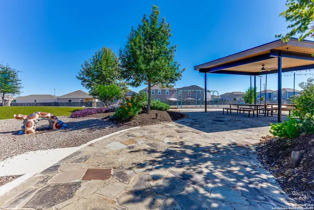 a view of a backyard with sitting area