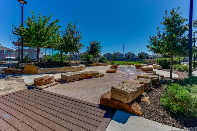 a view of a backyard with couches and swimming pool
