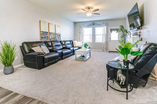 a living room with furniture potted plant and a window