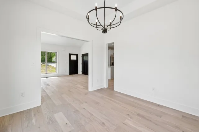 a view of a room with wooden floor and a ceiling fan