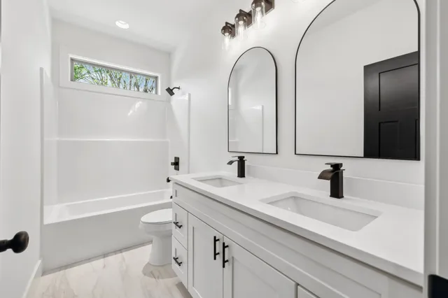a bathroom with a sink a toilet and a mirror