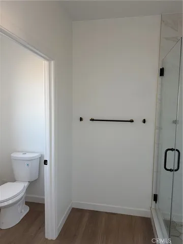 an empty room with wooden floor and door