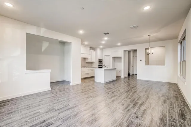 a kitchen with stainless steel appliances granite countertop a sink and a stove
