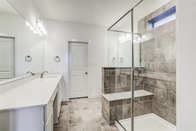 a view of an empty room and chandelier fan