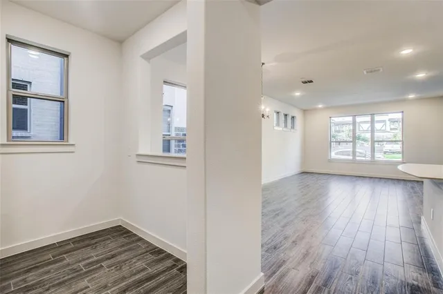 a view of entryway and hall with wooden floor