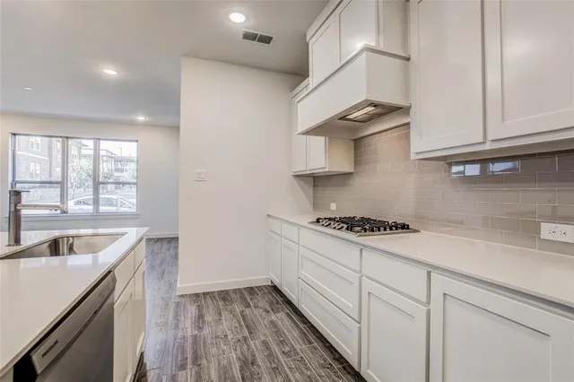 a kitchen with a sink stove and cabinets