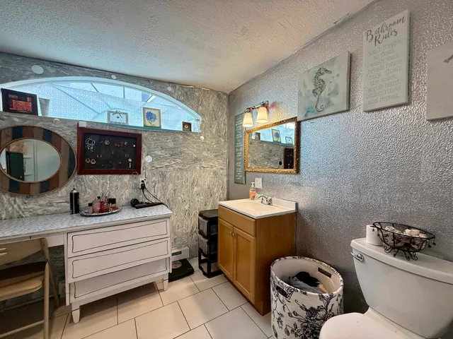 a bathroom with a toilet sink and mirror