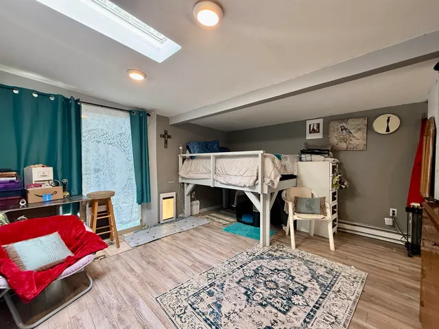 a bedroom with furniture and a wooden floor
