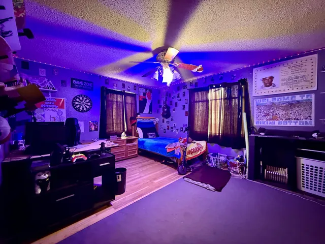 a living room with furniture a chandelier and a dining table