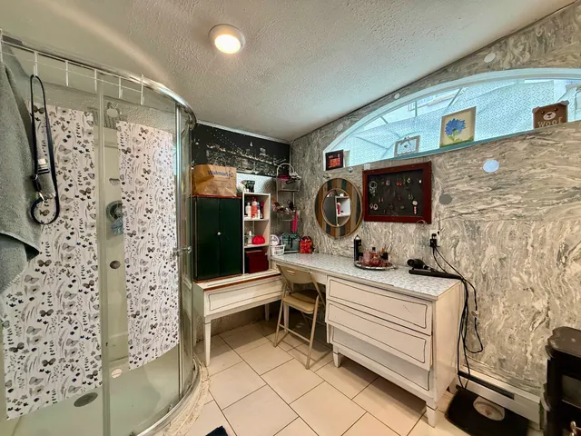 a bathroom with a sink a mirror and shower