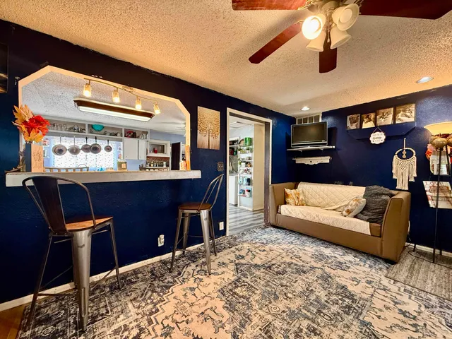 a living room with a couch and a dining table