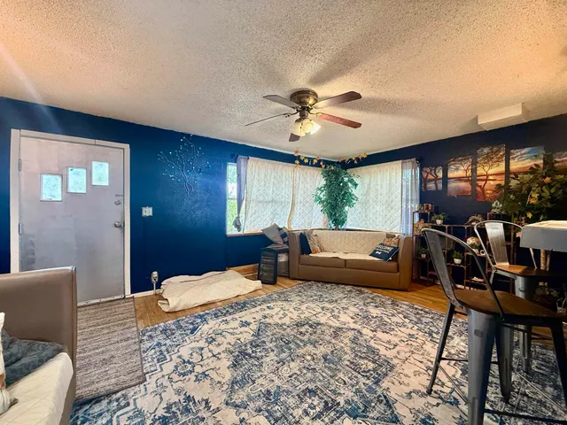 a bedroom with a bed a couch and dresser