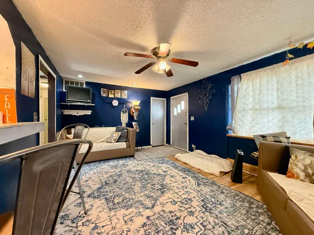 a bedroom with a bed couch and window