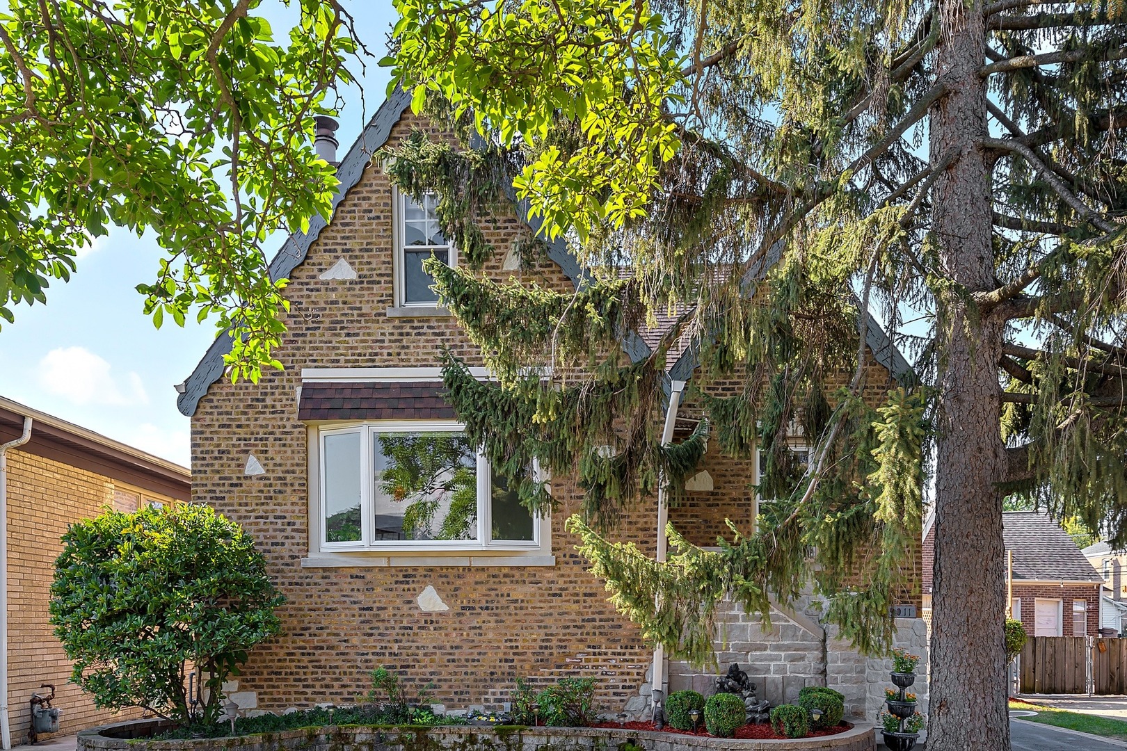 9011 24th Street Riverside, IL 60546 - Photo 1 of 22 front view of a house with a tree