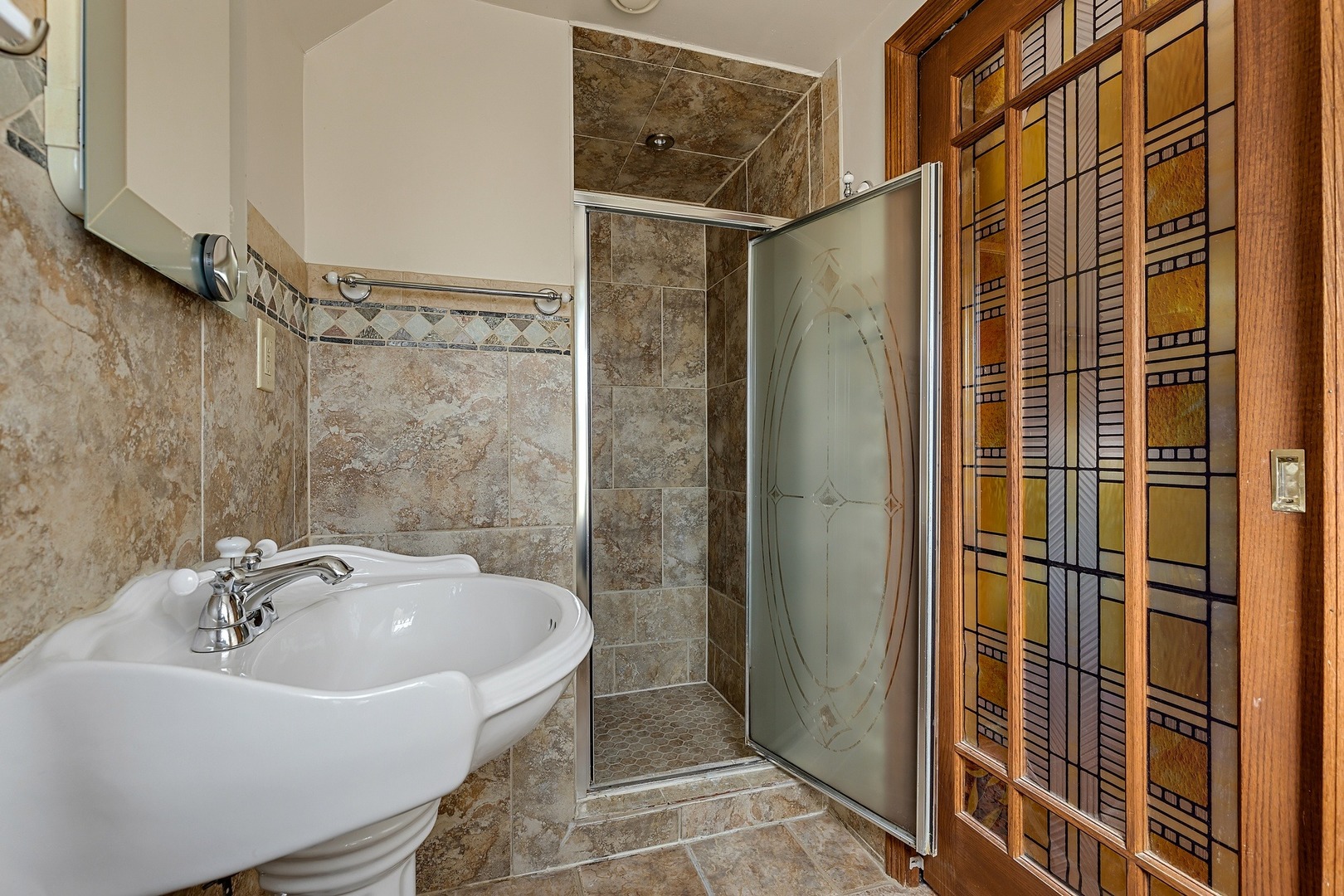 9011 24th Street Riverside, IL 60546 - Photo 11 of 22 a bathroom with a sink and shower