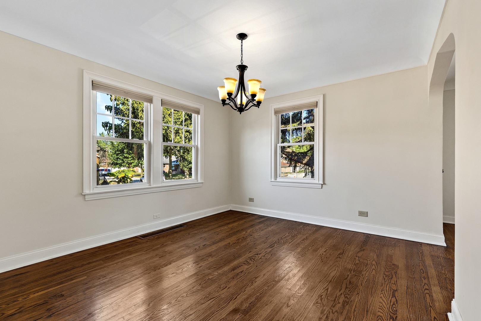 9011 24th Street Riverside, IL 60546 - Photo 4 of 22 a view of an empty room with wooden floor and windows
