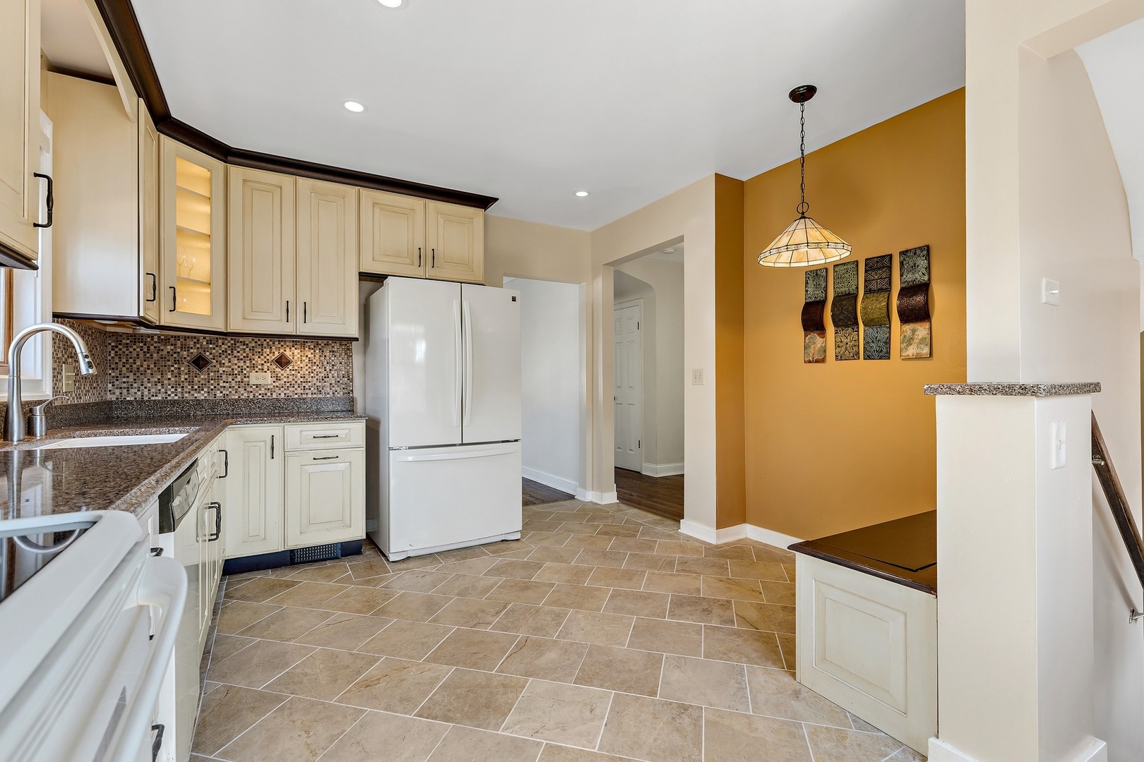 9011 24th Street Riverside, IL 60546 - Photo 6 of 22 a kitchen with a refrigerator sink and cabinets