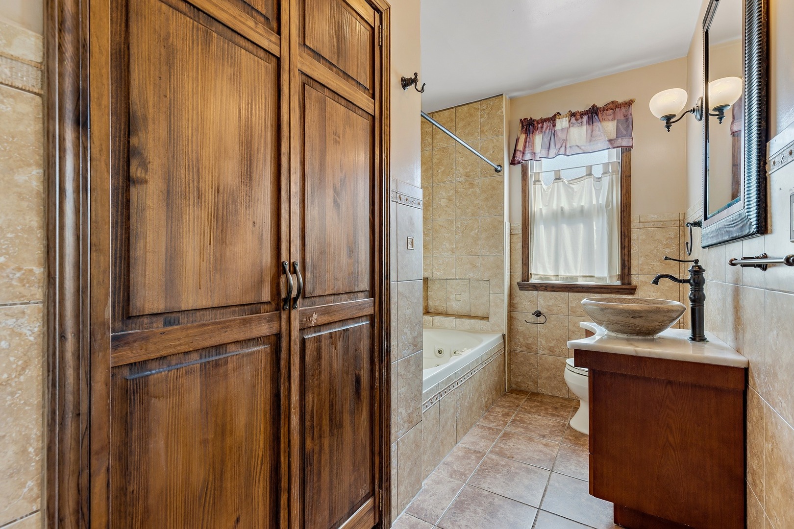 9011 24th Street Riverside, IL 60546 - Photo 7 of 22 a bathroom with a tub sink and mirror