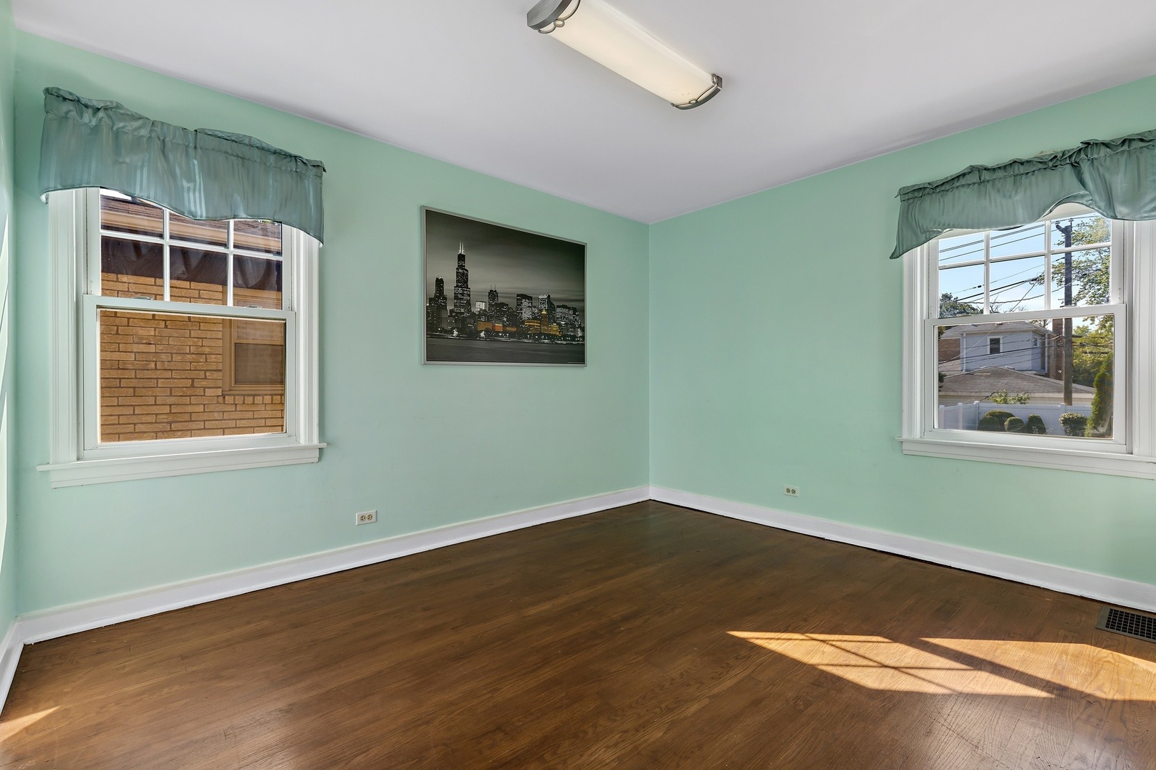 9011 24th Street Riverside, IL 60546 - Photo 8 of 22 an empty room with wooden floor and windows