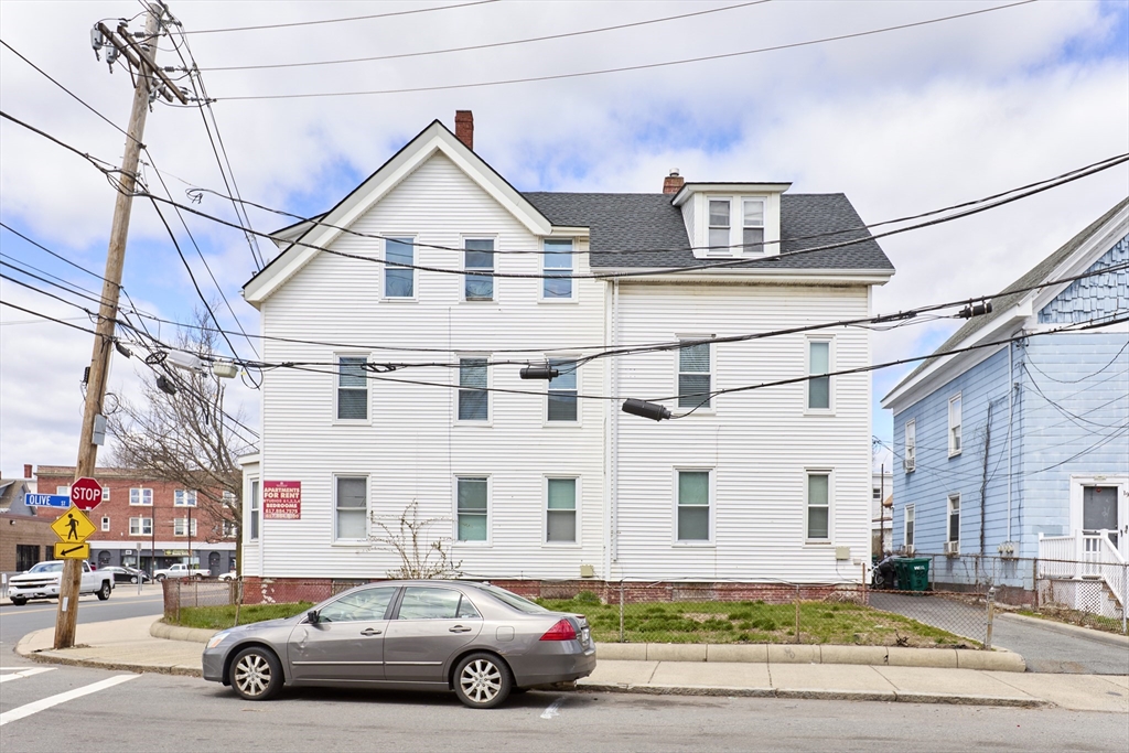 133 Chestnut Street Lynn, MA 01902 - Photo 6 of 12 a car parked in front of a white house