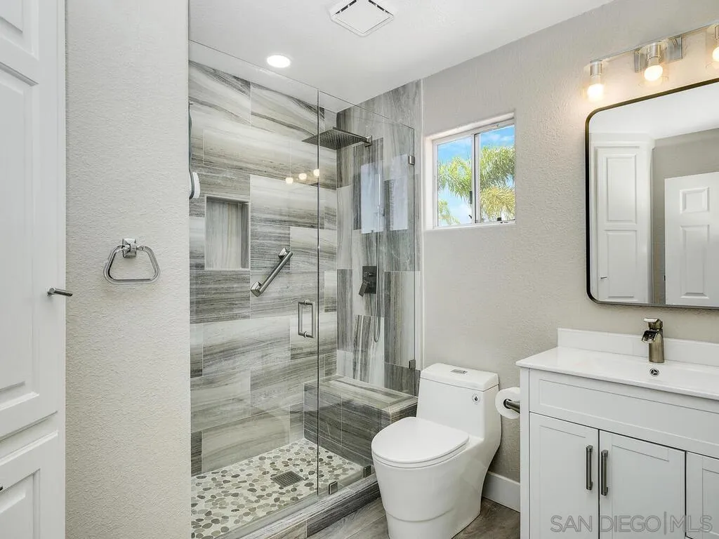 4843 Marathon Way Oceanside, CA 92056 - Photo 36 of 75 a bathroom with a granite countertop sink toilet and shower