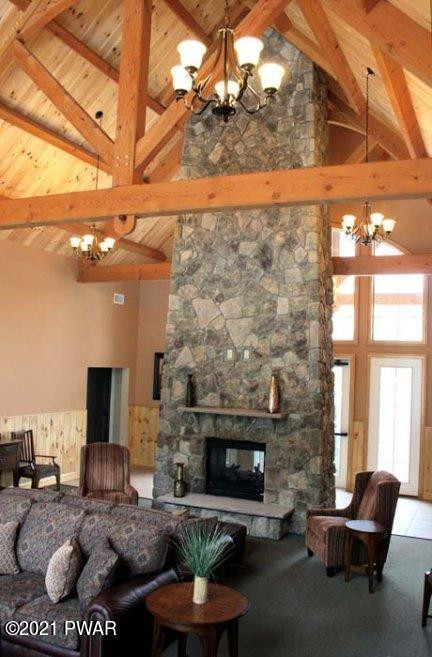 402 MacIntosh Way Matamoras, PA 18336 - Photo 16 of 17 a living room with furniture a fireplace and a flat screen tv
