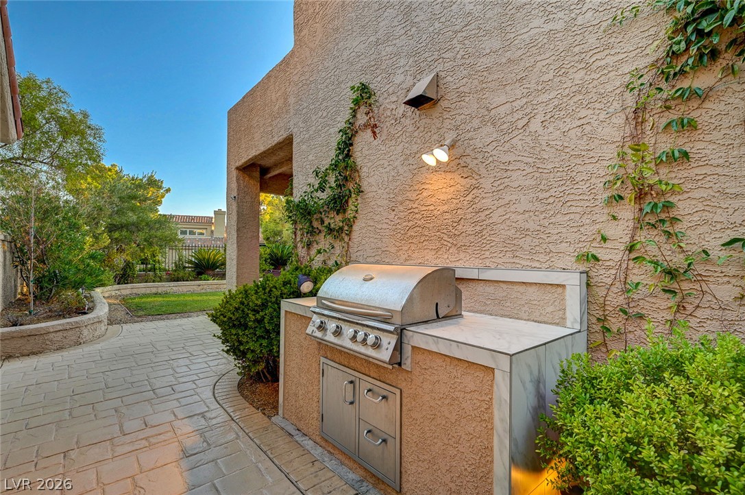 7995 Rio Rico Drive Las Vegas, NV 89113 - Photo 49 of 92 An outdoor kitchen with a built-in grill and ample counter space for effortless entertaining.