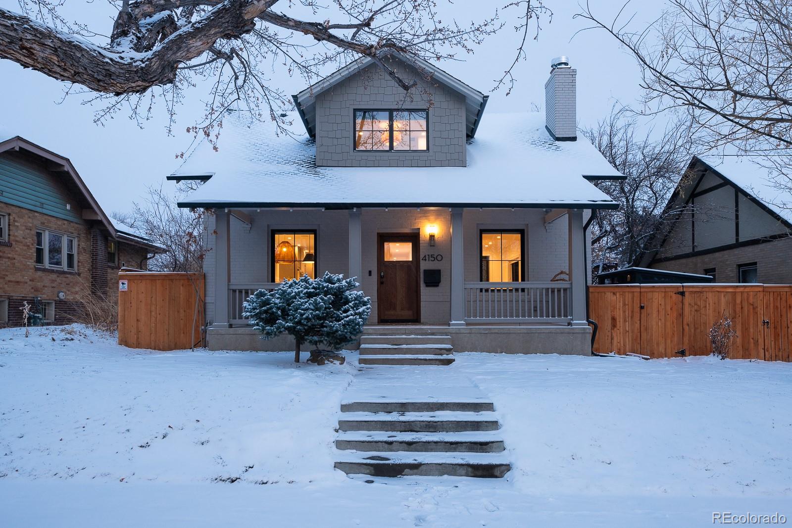 a view of house and yard with potted plants