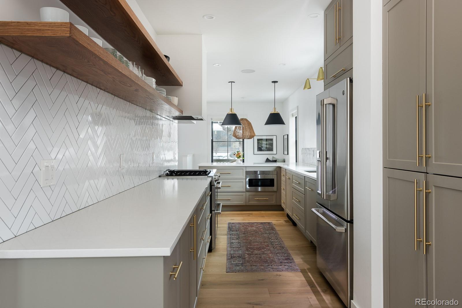 4150 Hooker Street Denver, CO 80211 - Photo 15 of 40 a kitchen with stainless steel appliances a refrigerator and a sink