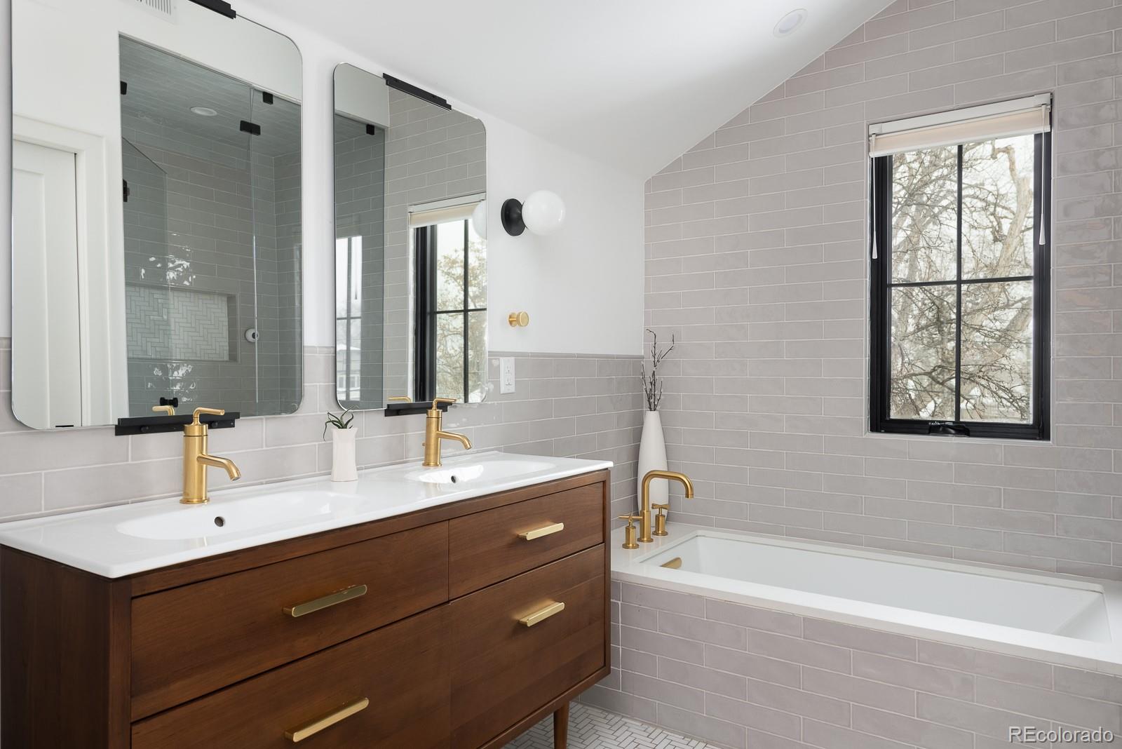 4150 Hooker Street Denver, CO 80211 - Photo 23 of 40 a bathroom with a tub sink double vanity granite and a mirror
