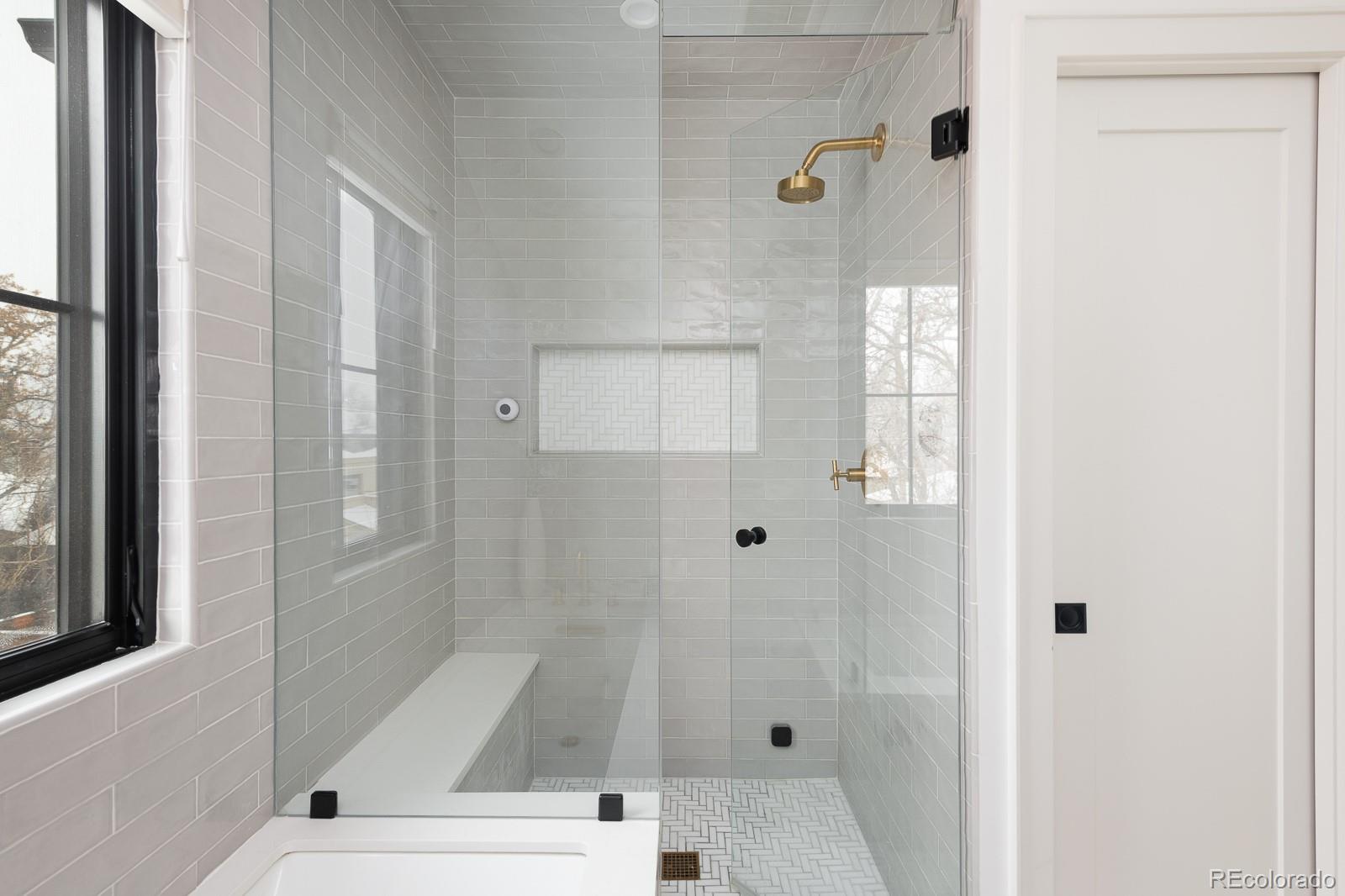4150 Hooker Street Denver, CO 80211 - Photo 24 of 40 a bathroom with a white bath tub sitting next to a window