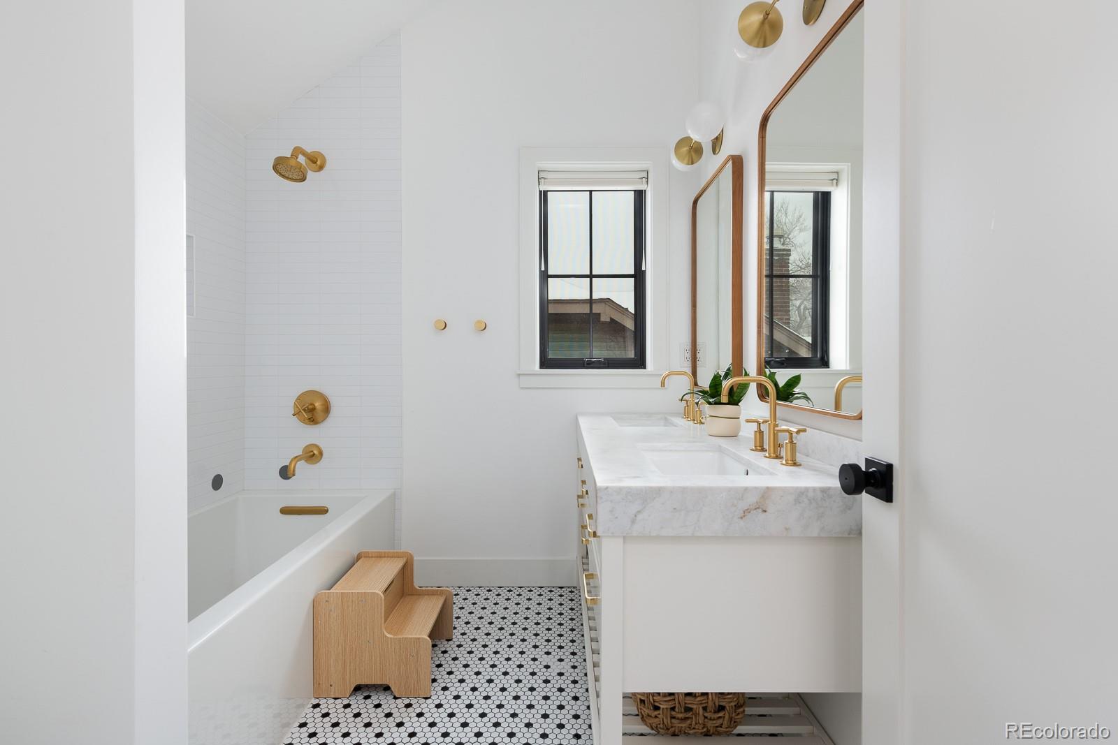 4150 Hooker Street Denver, CO 80211 - Photo 27 of 40 a bathroom with a sink a mirror and shower