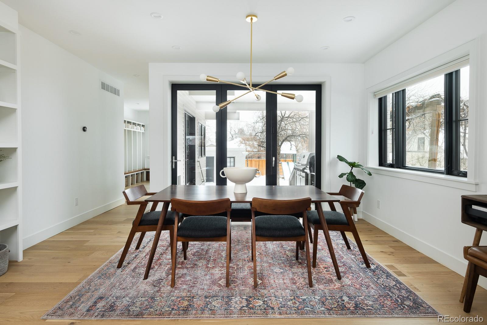 4150 Hooker Street Denver, CO 80211 - Photo 8 of 40 a dining room with furniture a chandelier and wooden floor