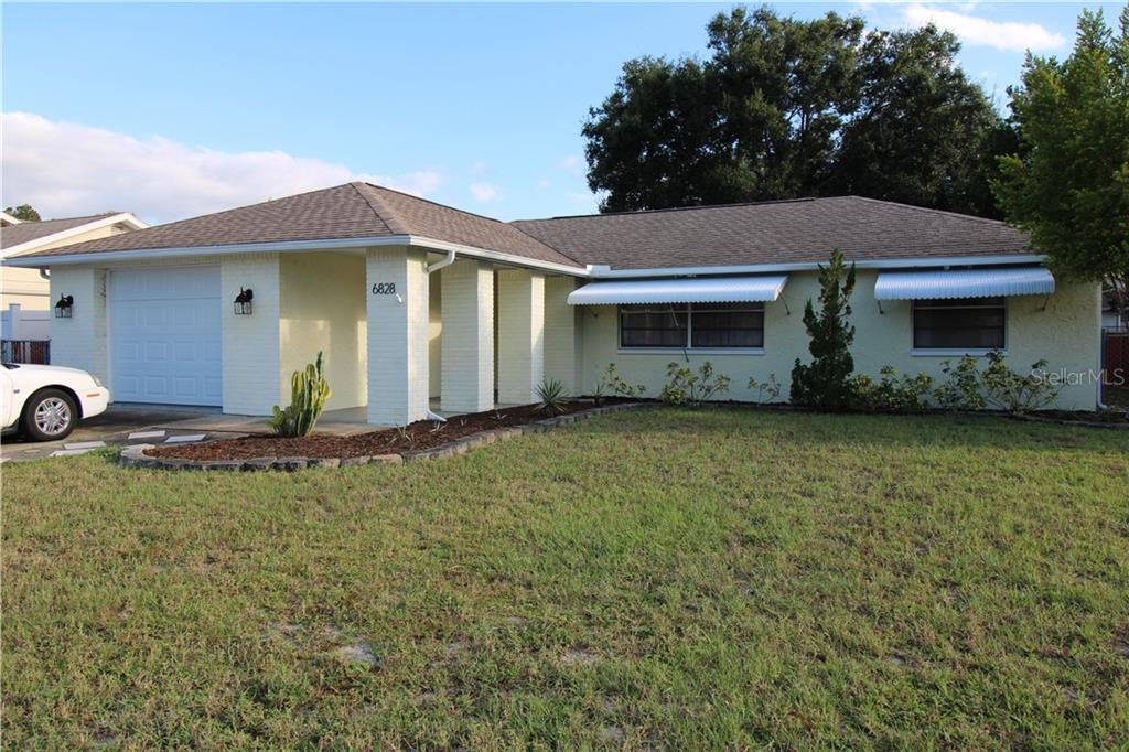 6828 Greenwich Avenue New Port Richey, FL 34653 - Photo 1 of 1 a front view of a house with garden