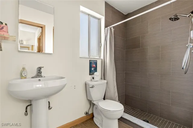 a bathroom with a sink toilet and a mirror