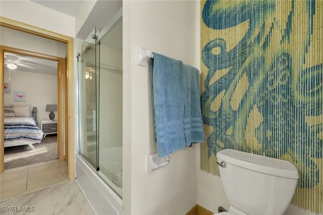 a bathroom with a toilet and a shower