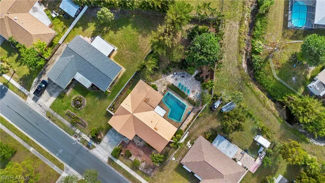an aerial view of a house with a garden and trees